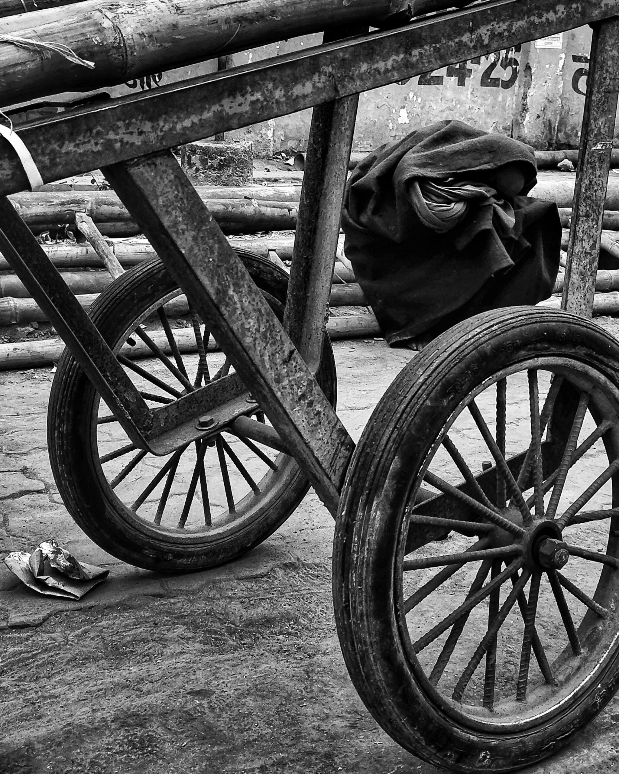 Detailed view of a rustic cart wheel in black and white.